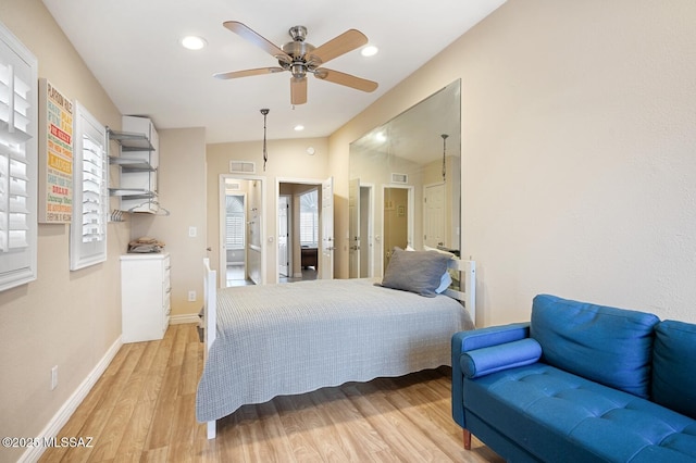 bedroom featuring ceiling fan, vaulted ceiling, and light wood-type flooring