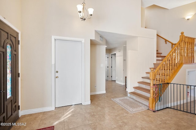 entryway with a notable chandelier and a high ceiling