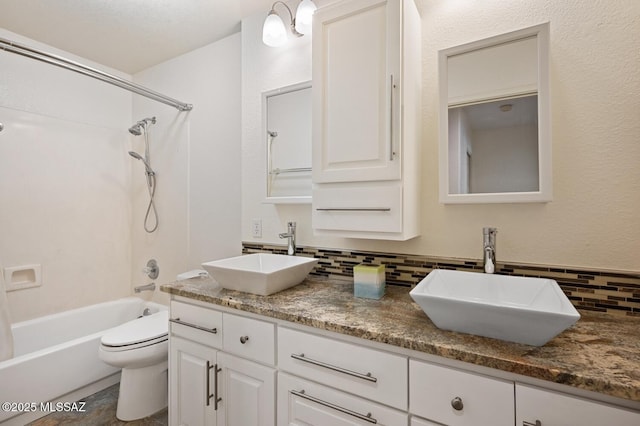 full bathroom with vanity, toilet, backsplash, and shower / bathing tub combination