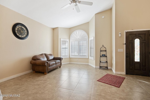 entrance foyer featuring light tile patterned floors, high vaulted ceiling, and ceiling fan