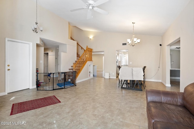 living room featuring ceiling fan with notable chandelier and high vaulted ceiling