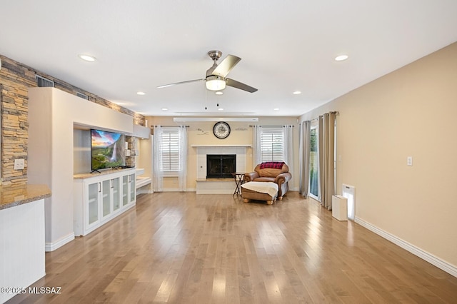 unfurnished living room with light hardwood / wood-style flooring and ceiling fan