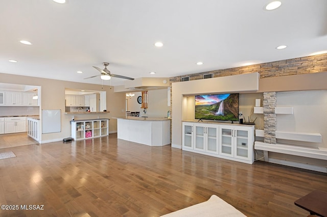 living room with wood-type flooring and ceiling fan