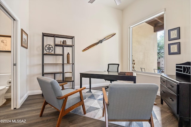 home office with dark wood-type flooring and ceiling fan