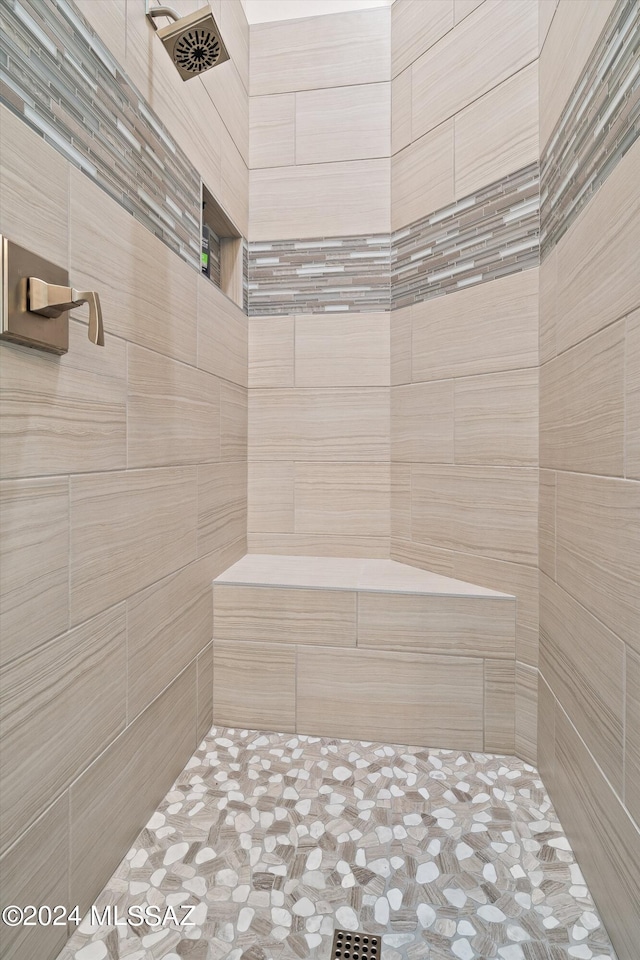 bathroom with a tile shower