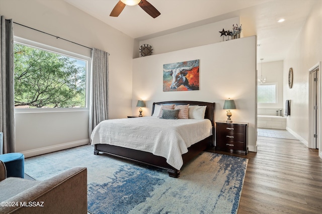 bedroom with hardwood / wood-style flooring, ceiling fan, and connected bathroom