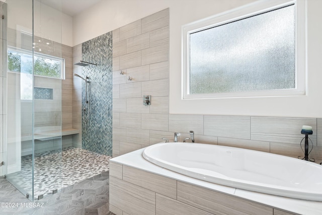 bathroom with separate shower and tub