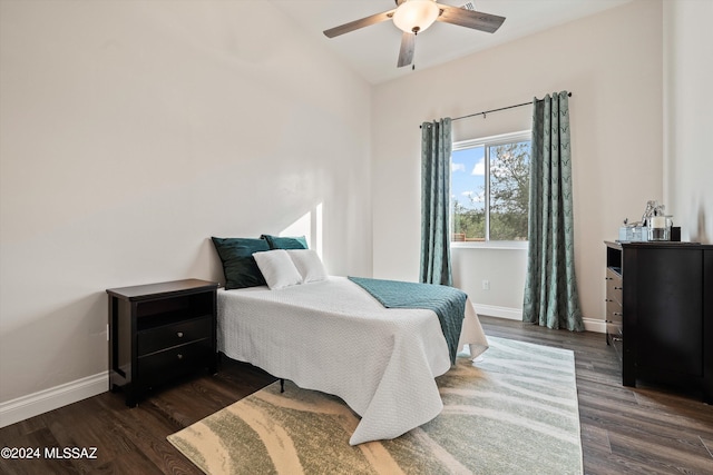 bedroom with ceiling fan, lofted ceiling, and dark hardwood / wood-style flooring