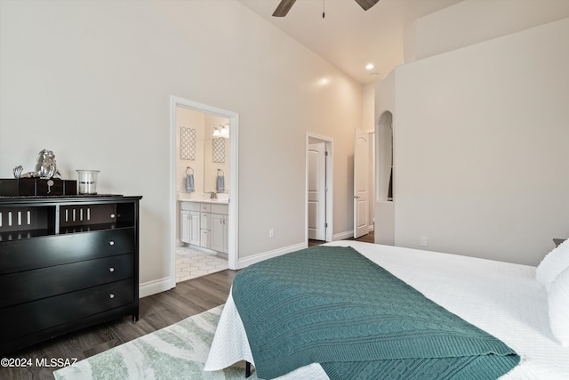 bedroom with a high ceiling, sink, dark hardwood / wood-style flooring, and ensuite bath