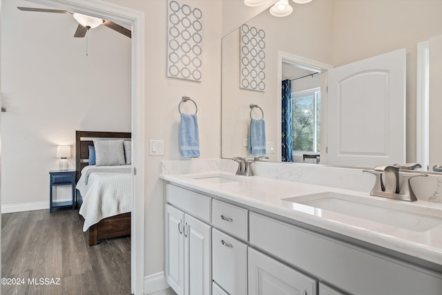 bathroom with vanity, hardwood / wood-style floors, and ceiling fan