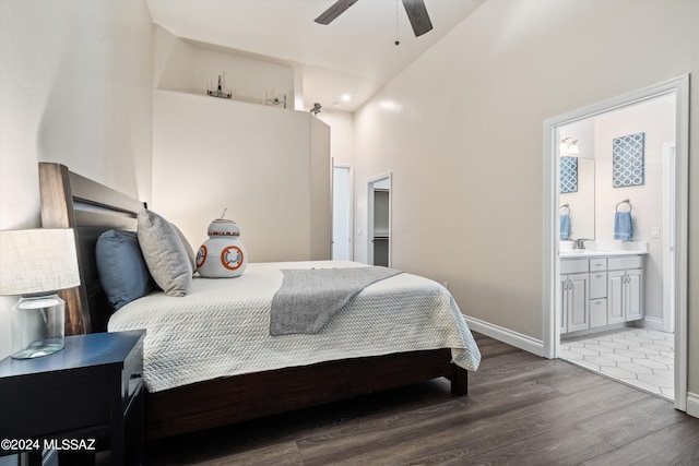 bedroom with ceiling fan, connected bathroom, and dark hardwood / wood-style flooring