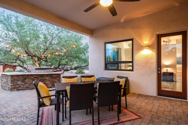 view of patio with an outdoor kitchen, an outdoor bar, and ceiling fan