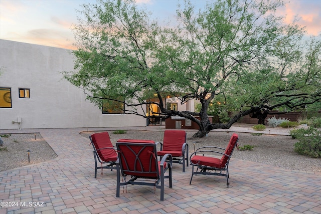 patio terrace at dusk featuring a fire pit