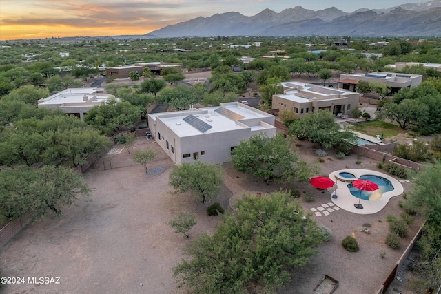 aerial view at dusk featuring a mountain view