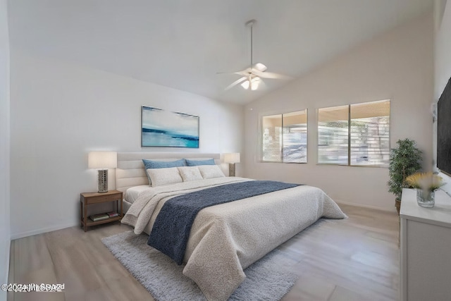 bedroom with light wood-type flooring, ceiling fan, and lofted ceiling