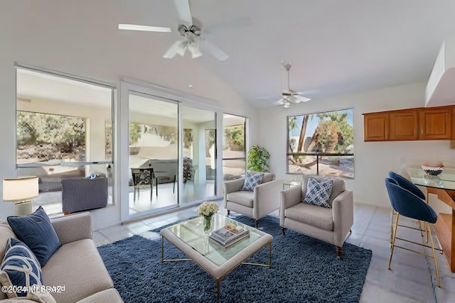 living room with ceiling fan, lofted ceiling, and light tile patterned flooring