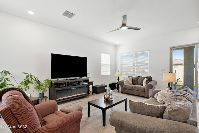 living room featuring ceiling fan and light hardwood / wood-style floors