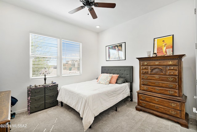 bedroom featuring ceiling fan and light carpet