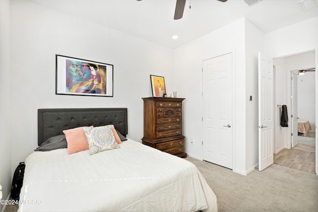 bedroom with ceiling fan and light carpet