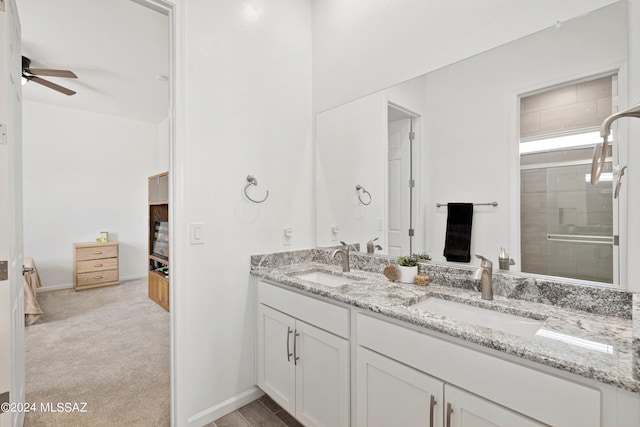 bathroom with walk in shower, vanity, and ceiling fan