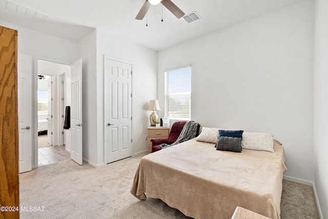 bedroom with light colored carpet and ceiling fan