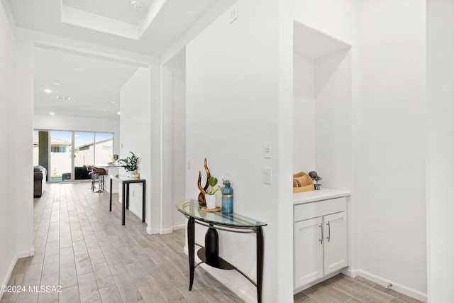 hallway with light hardwood / wood-style flooring