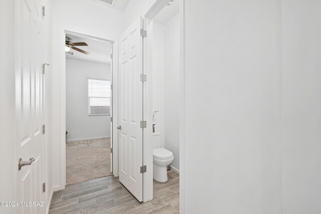 bathroom featuring ceiling fan, toilet, and hardwood / wood-style floors