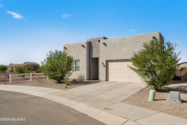 pueblo-style home featuring a garage