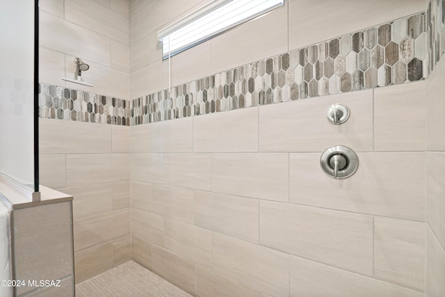 bathroom with tiled shower