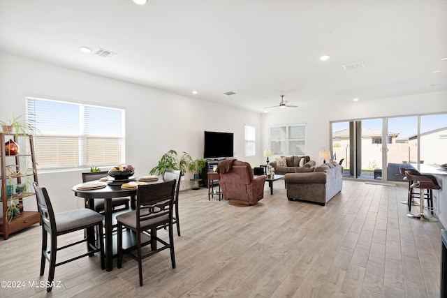 dining area featuring ceiling fan, light hardwood / wood-style flooring, and a wealth of natural light