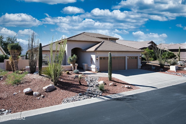 ranch-style house with an attached garage, stucco siding, driveway, and a tiled roof