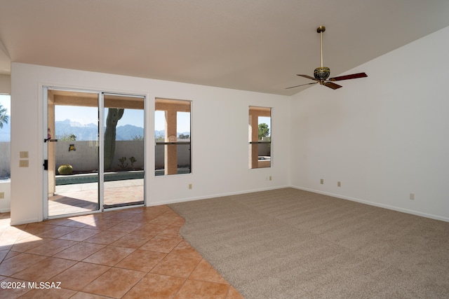 tiled spare room with a mountain view and ceiling fan