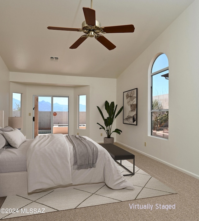 bedroom featuring ceiling fan, light colored carpet, and lofted ceiling