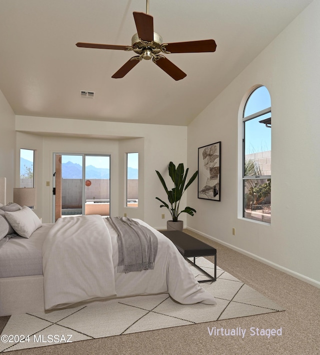 bedroom featuring multiple windows, visible vents, access to exterior, and lofted ceiling