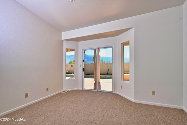empty room with carpet floors and baseboards
