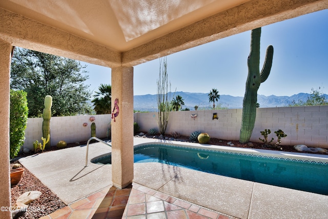 view of pool featuring a patio and a mountain view