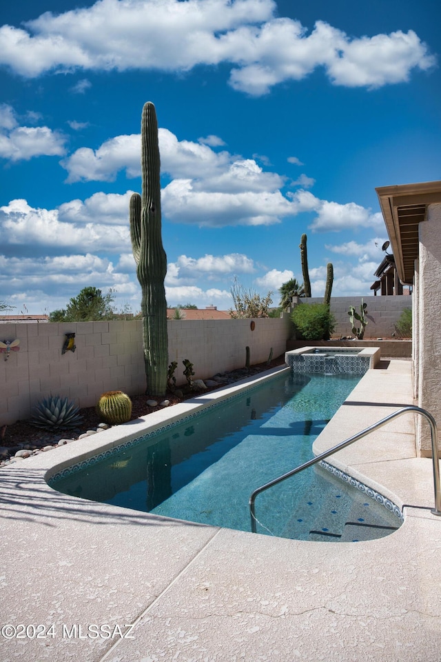 view of swimming pool featuring a fenced backyard, a patio area, and a pool with connected hot tub