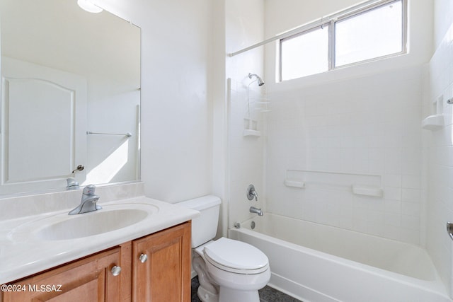 full bathroom featuring tiled shower / bath, vanity, and toilet