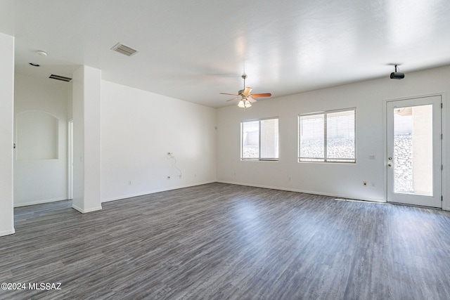 empty room with ceiling fan and dark wood-type flooring