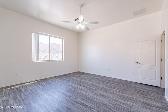 unfurnished room with ceiling fan and dark hardwood / wood-style flooring