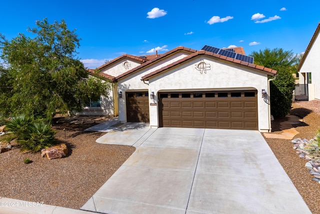 mediterranean / spanish-style house with a garage