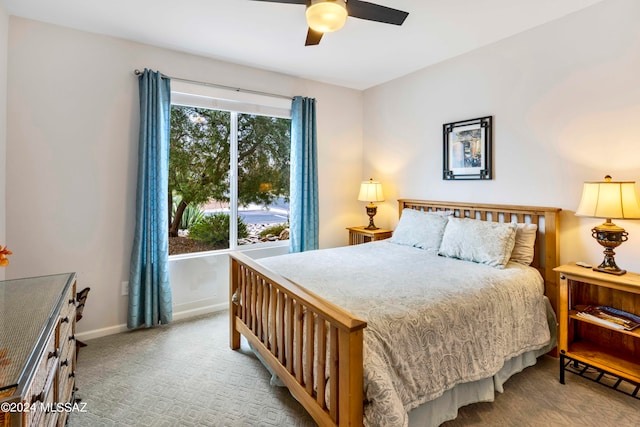 bedroom with ceiling fan and light carpet