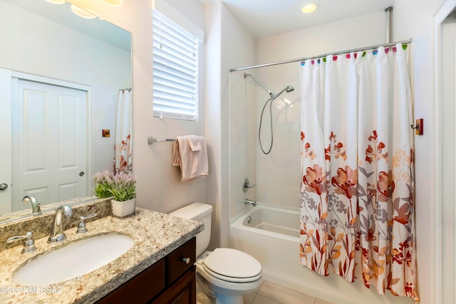 full bathroom featuring shower / bath combo with shower curtain, tile patterned floors, vanity, and toilet