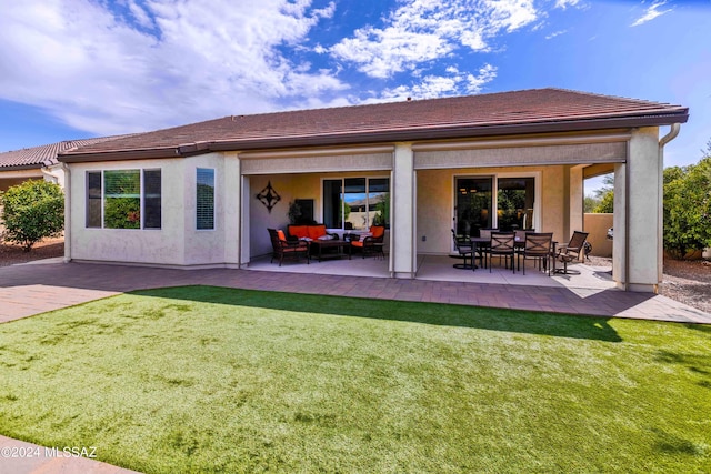 back of property with an outdoor living space, a yard, and a patio