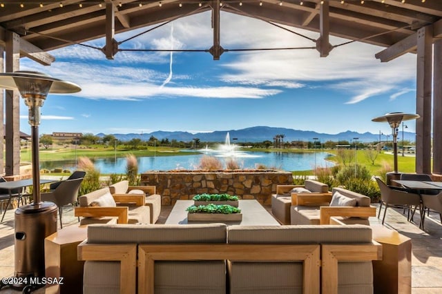 view of patio featuring a water and mountain view