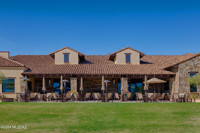 back of house featuring a yard and a patio area