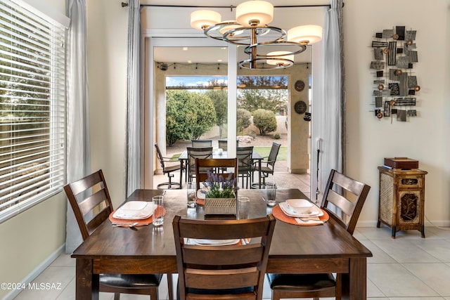 dining area featuring light tile patterned floors and a chandelier