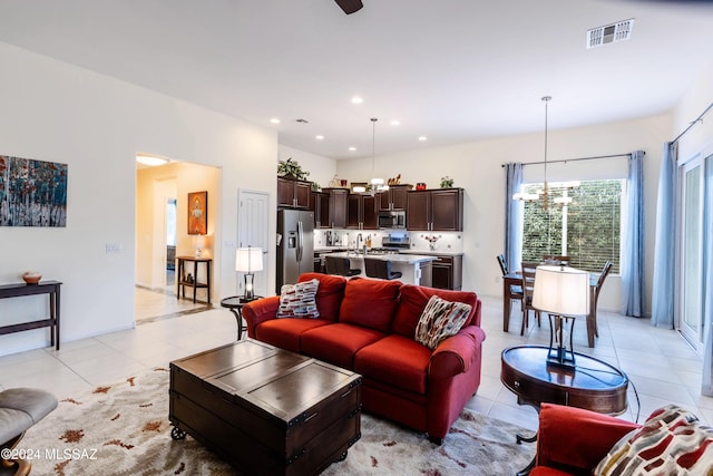 tiled living room featuring an inviting chandelier and sink