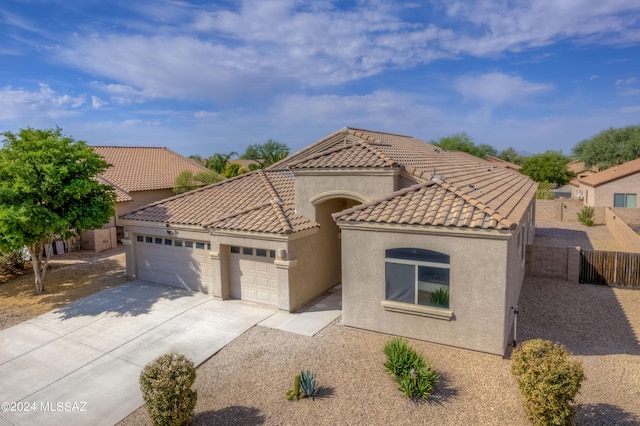 mediterranean / spanish-style home with a garage