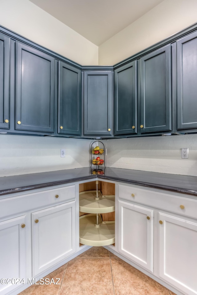 laundry area with light tile patterned floors